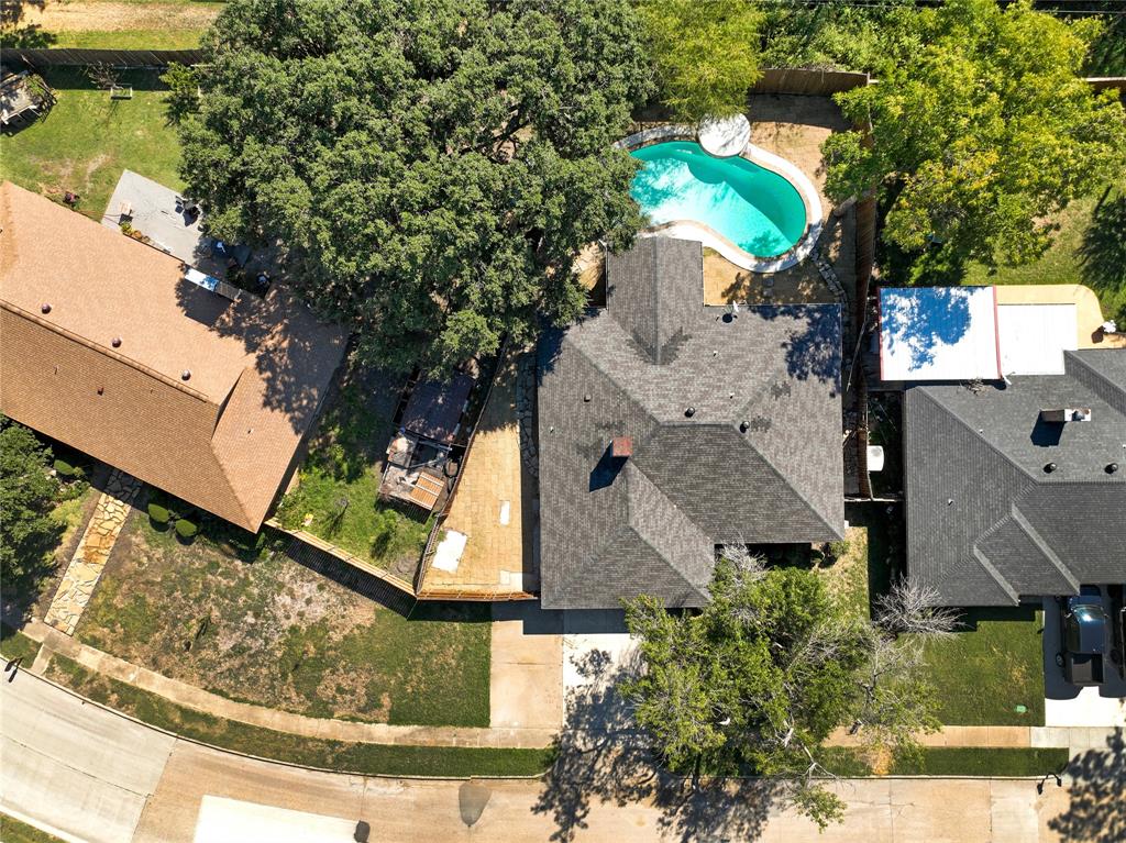 an aerial view of a house with a yard basket ball court and outdoor seating