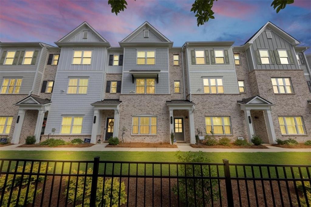 a front view of a residential apartment building with a yard