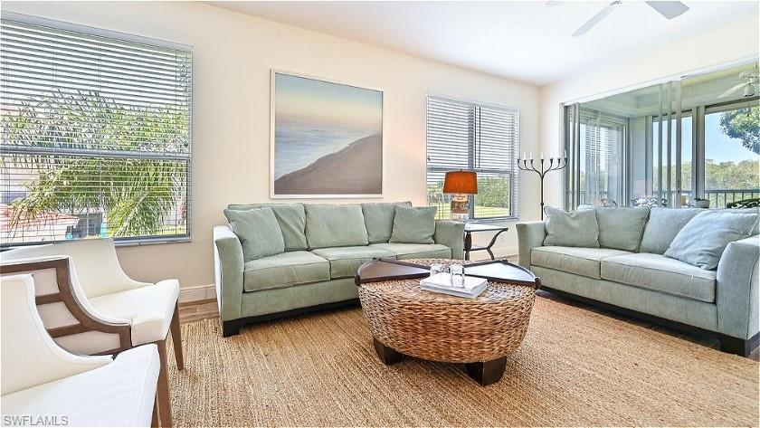 a living room with furniture and a large window