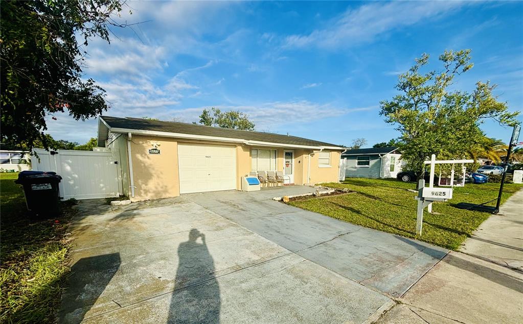 a view of a house with a yard and garage