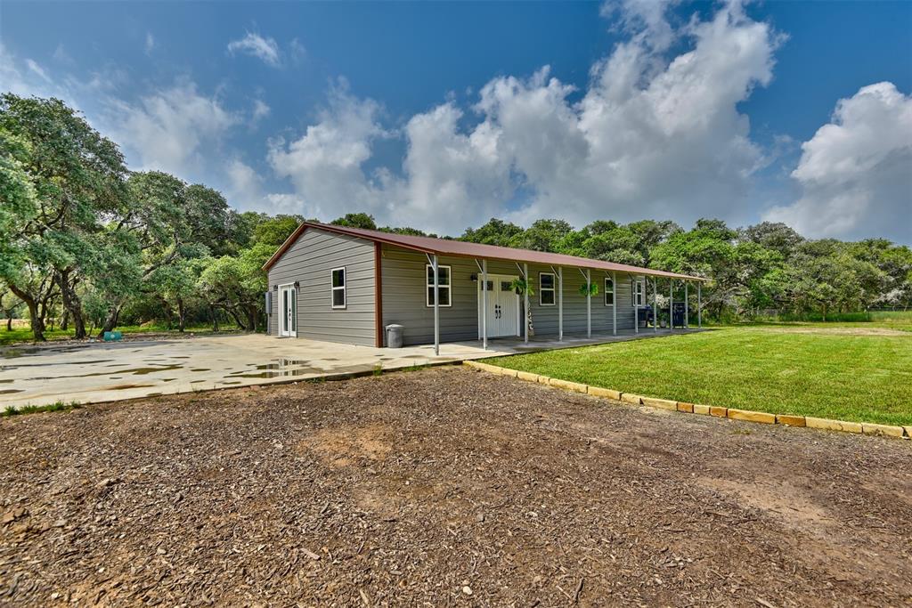 a view of house with yard and entertaining space