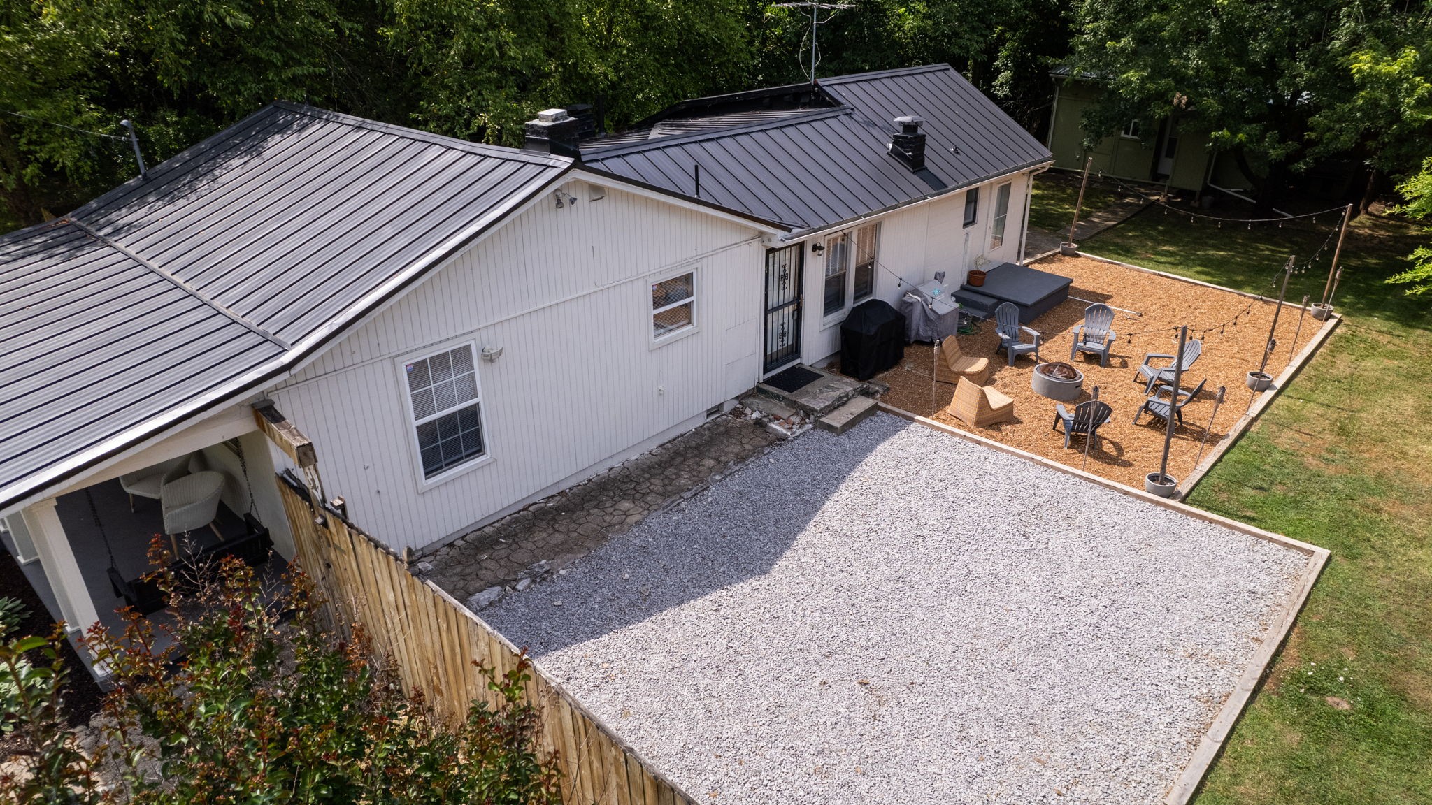 a view of a house with a yard and wooden fence