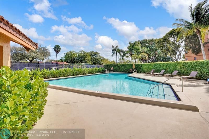 a view of a swimming pool with a patio