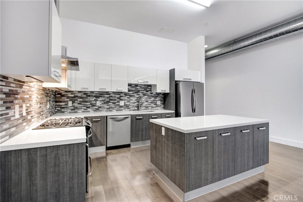 a kitchen with a stove top oven and cabinets