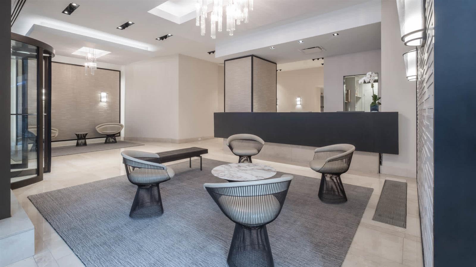 a living room with furniture a table and a chandelier