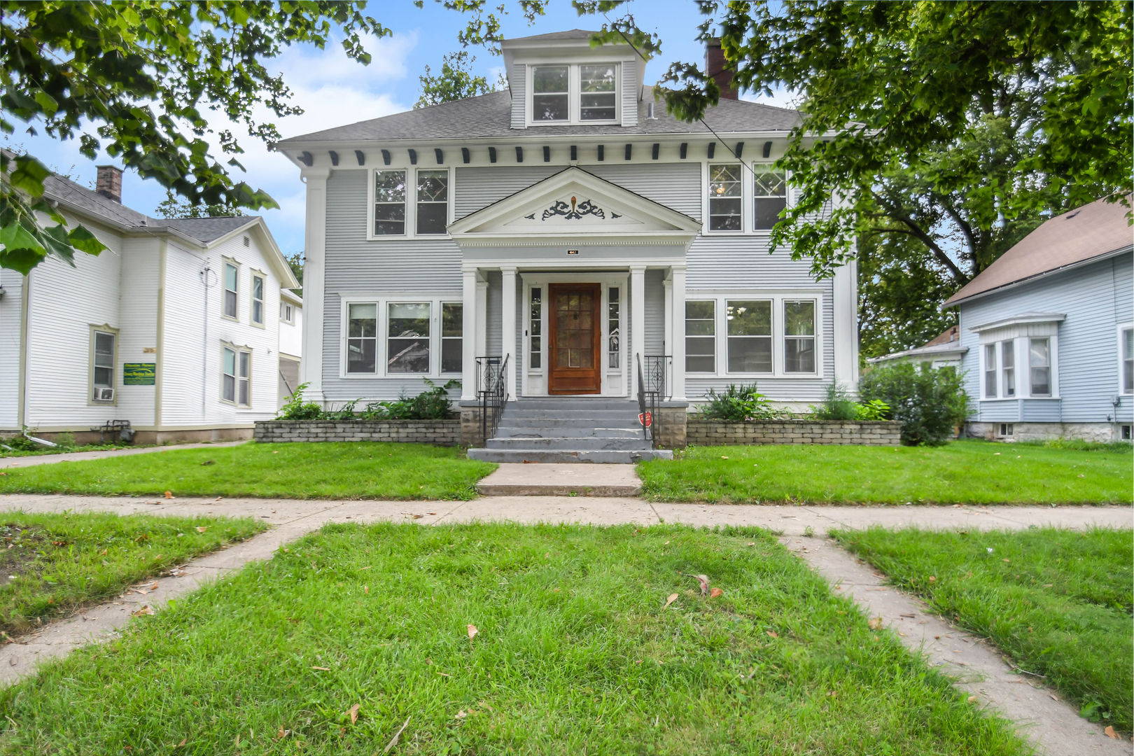 front view of a house next to a yard