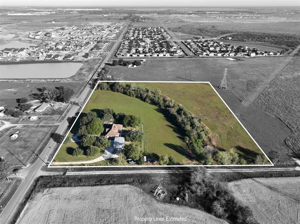 an aerial view of a residential houses with outdoor space