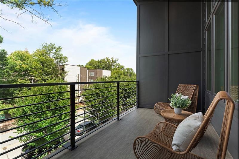 a balcony with couple of chairs