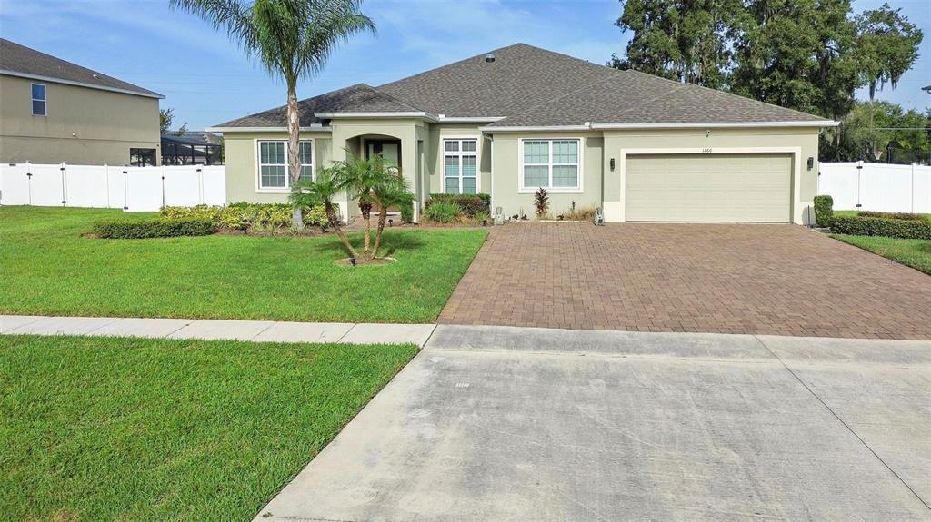 a front view of a house with a garden and yard