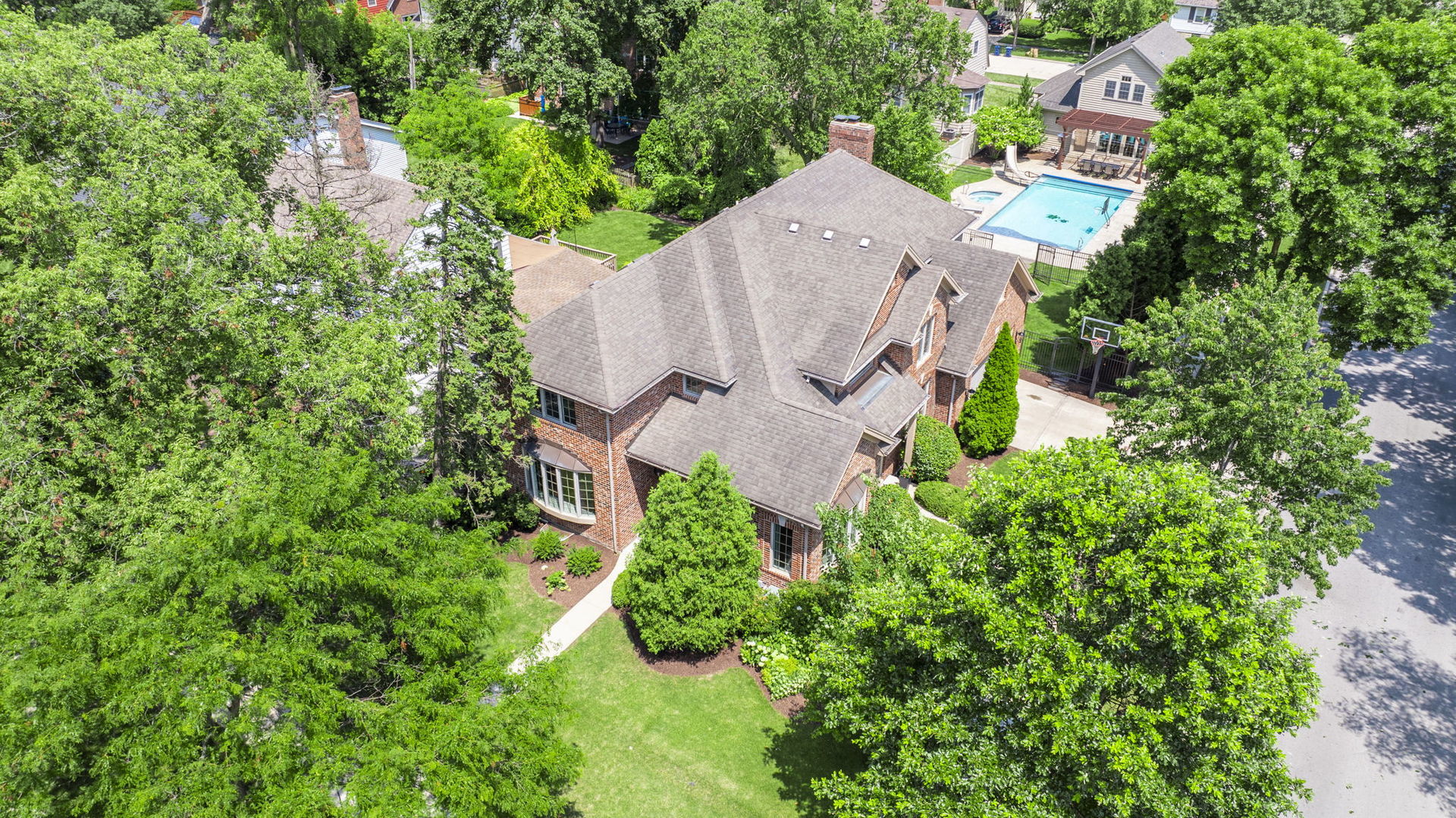 an aerial view of a house with a yard and trees