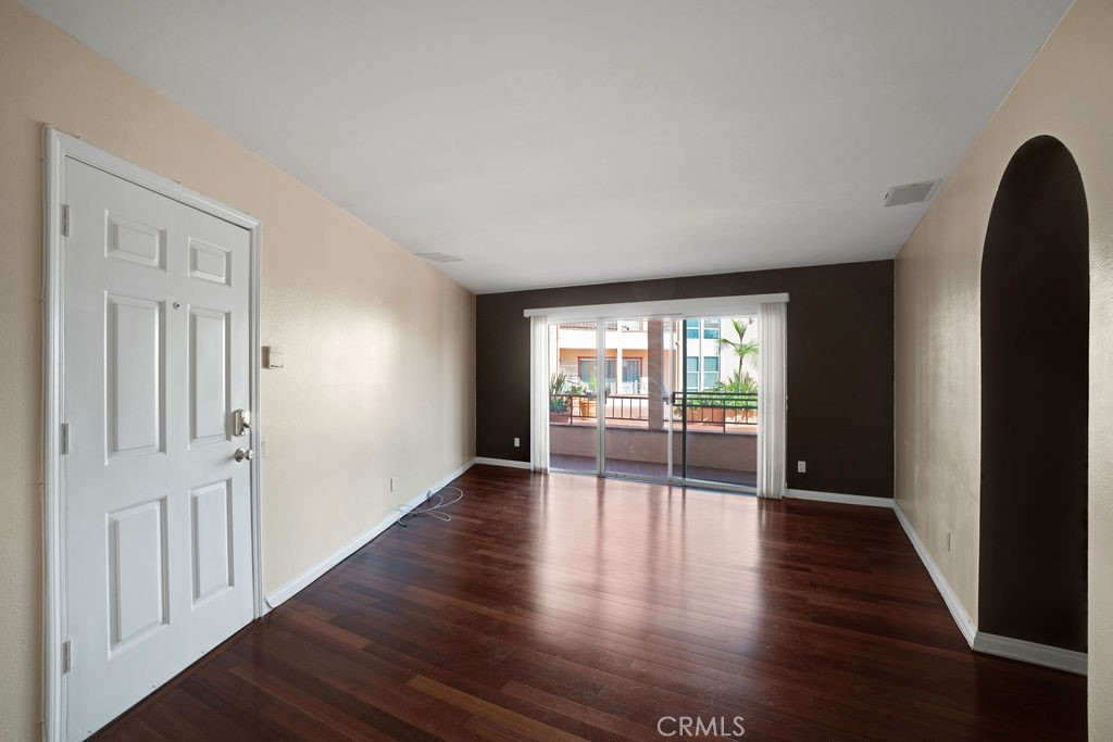 wooden floor in an empty room with a window