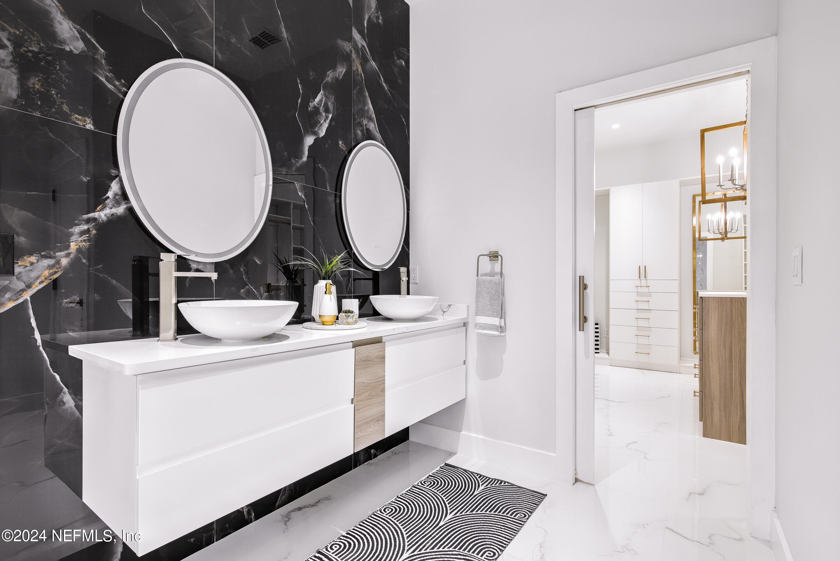 a bathroom with a double vanity sink and a mirror