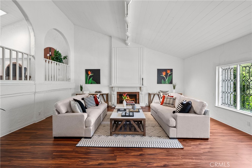 a living room with furniture and a fireplace