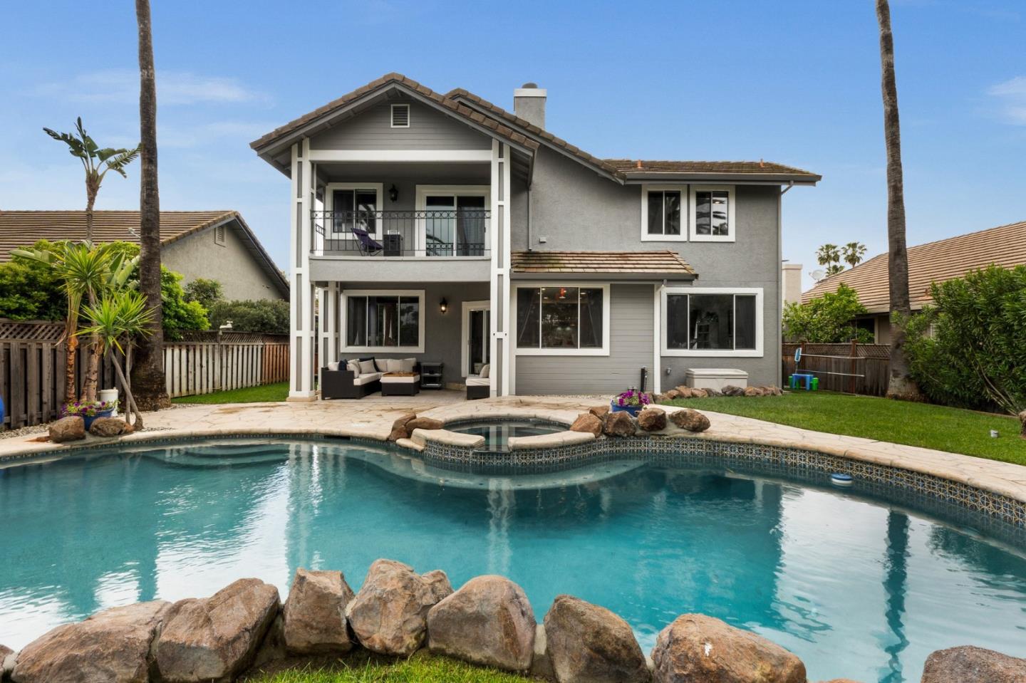 a view of a house with swimming pool and a yard