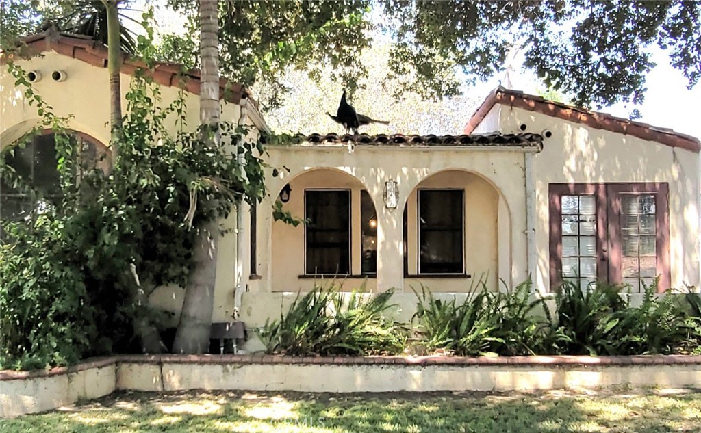 a front view of a house with swimming pool and glass windows