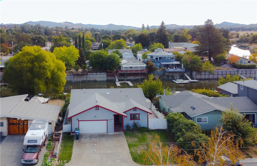 an aerial view of houses with a swimming pool and mountains