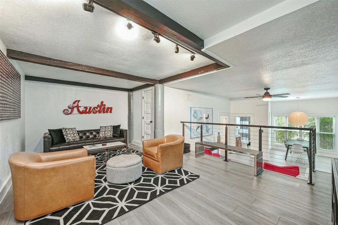 a living room with furniture and wooden floor