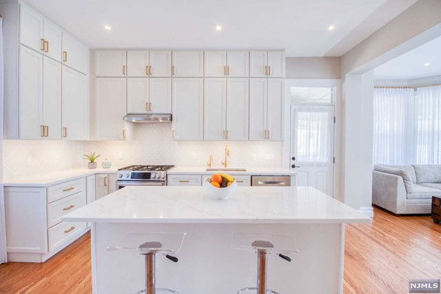 a kitchen with a sink a stove and refrigerator