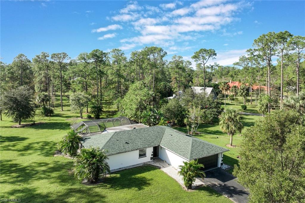 an aerial view of a house with yard