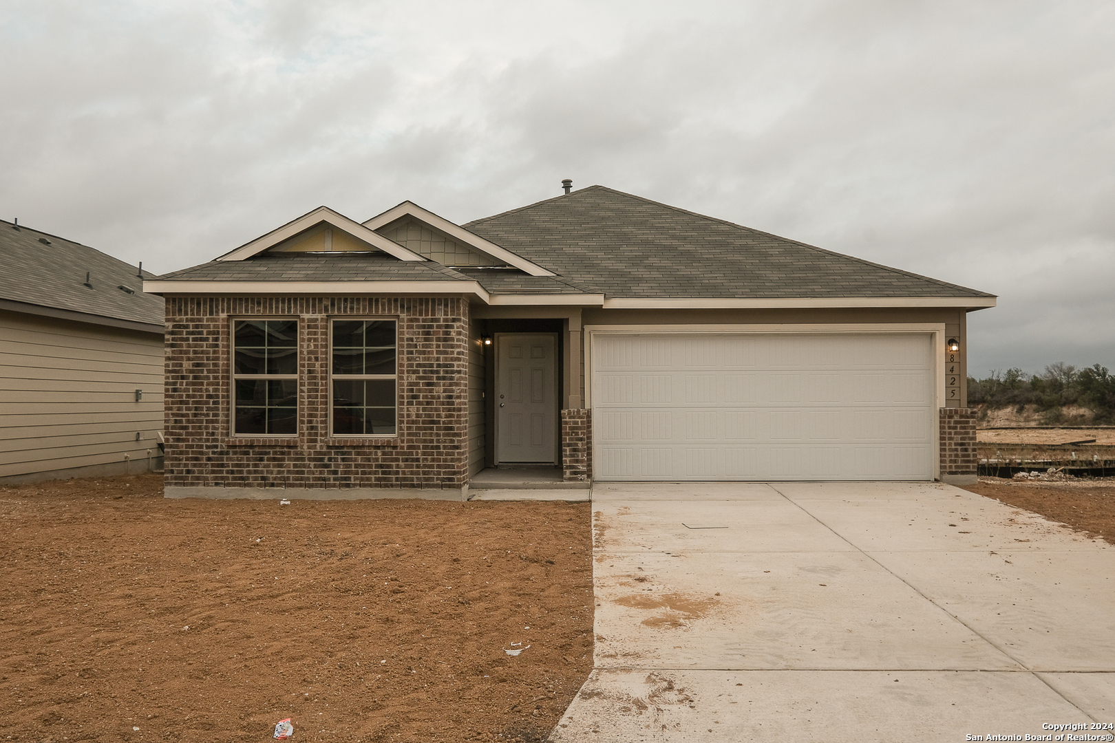 a front view of a house with a yard and garage