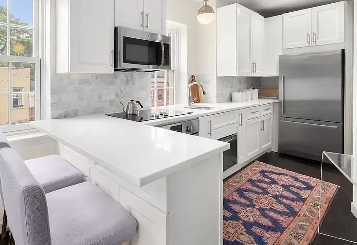 a kitchen with a sink stove and refrigerator