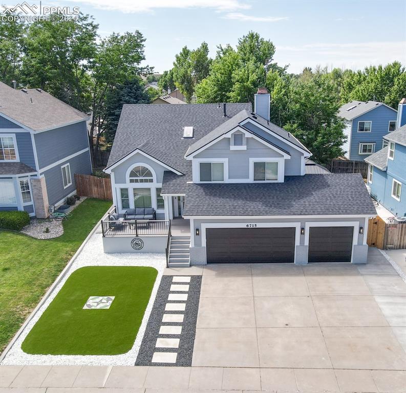 View of front of property with a garage and a front yard