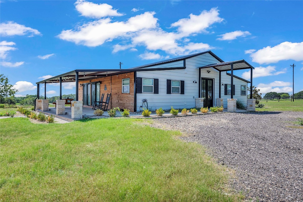 a front view of house with yard and green space