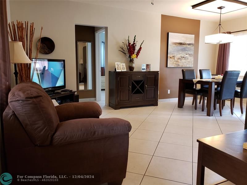 a living room with furniture a dining table and a fireplace