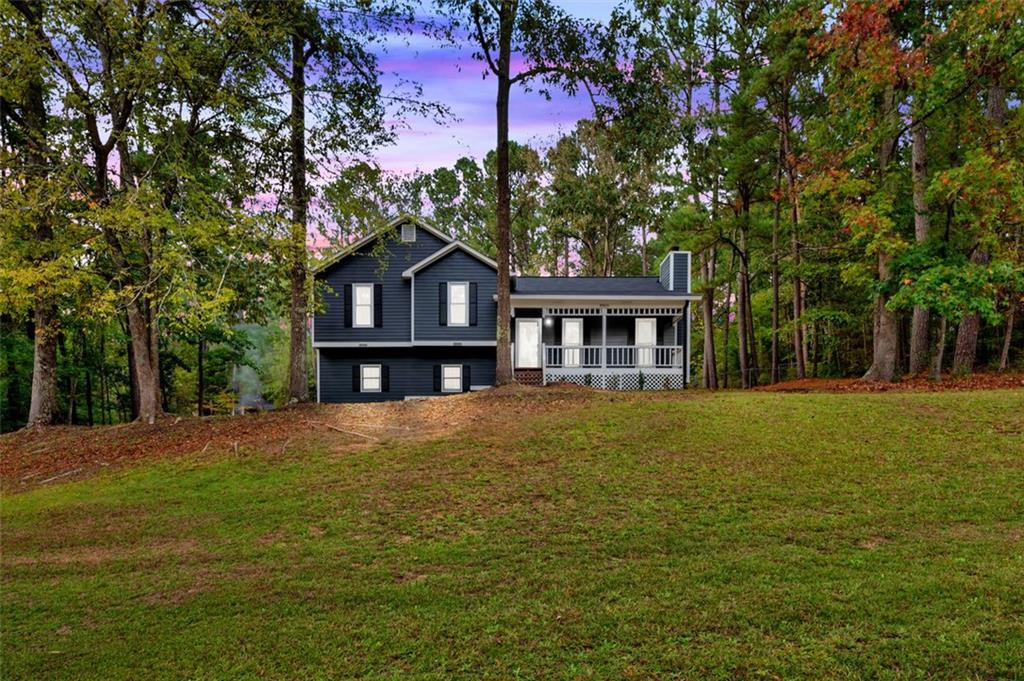 a front view of a house with a garden