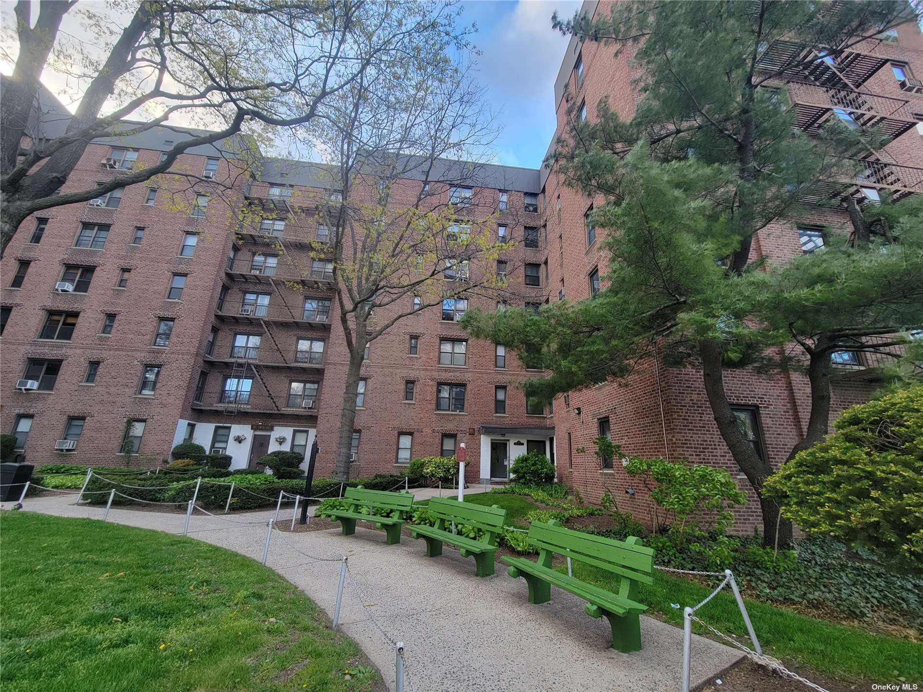 a view of a brick building next to a yard