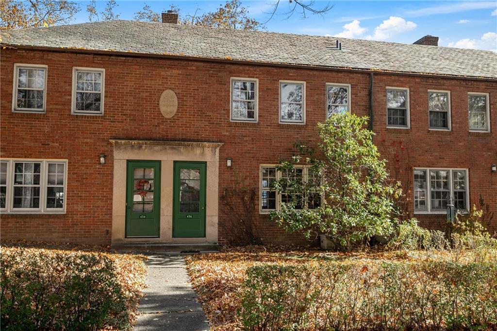 front view of a brick house with a large windows