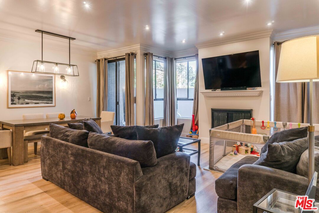 a living room with furniture fireplace and flat screen tv