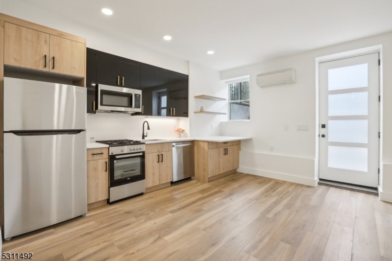 a kitchen with stainless steel appliances a refrigerator sink and microwave