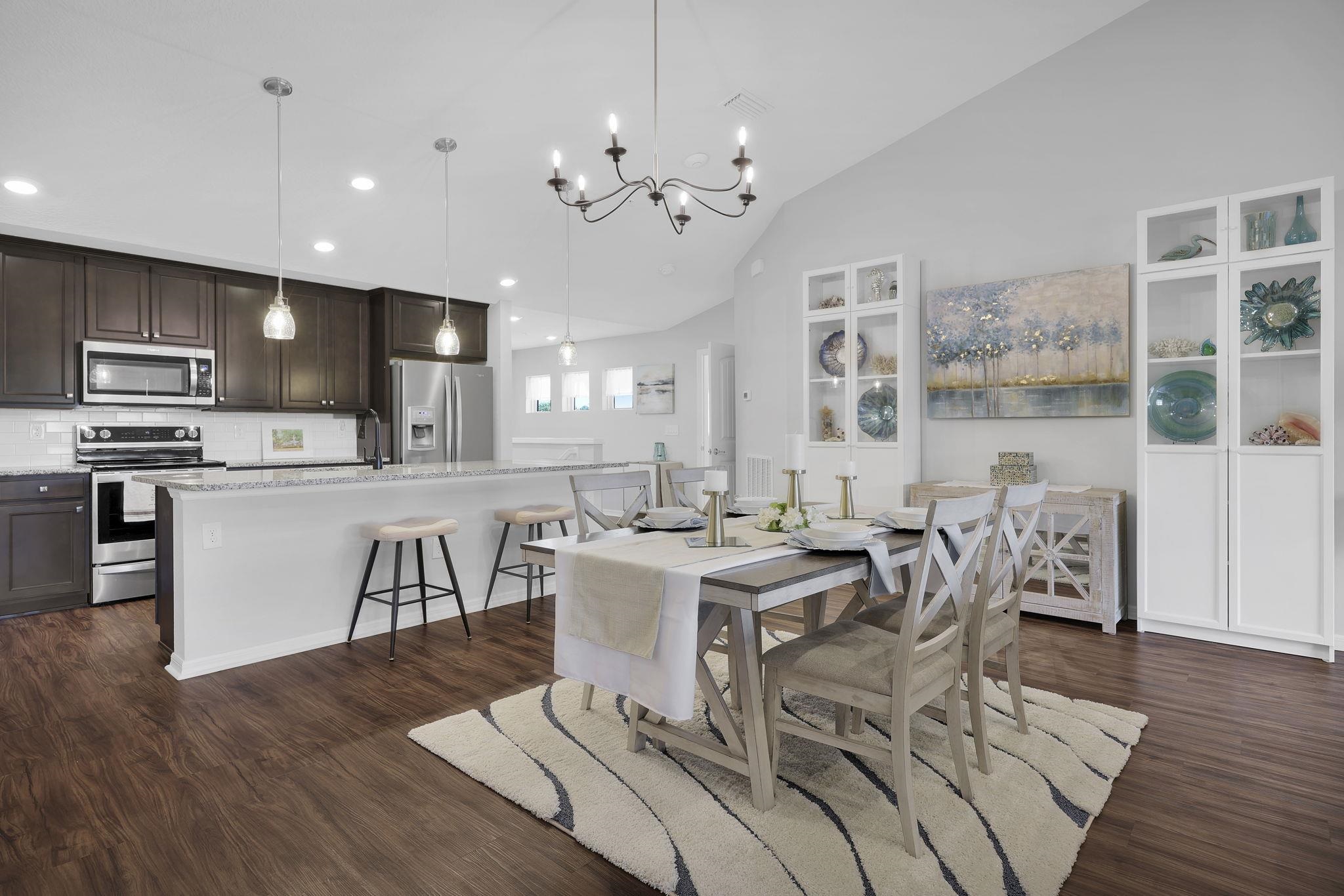 a view of a dining room with furniture kitchen and wooden floor