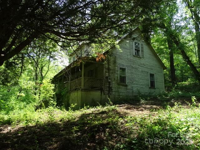 a yellow house with trees in front of it