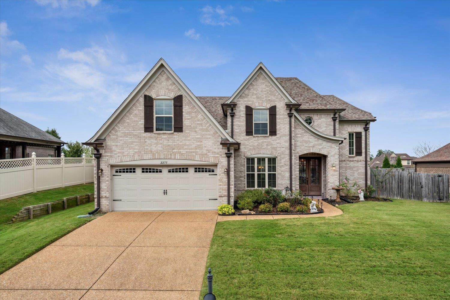 View of front of home with a front yard and a garage