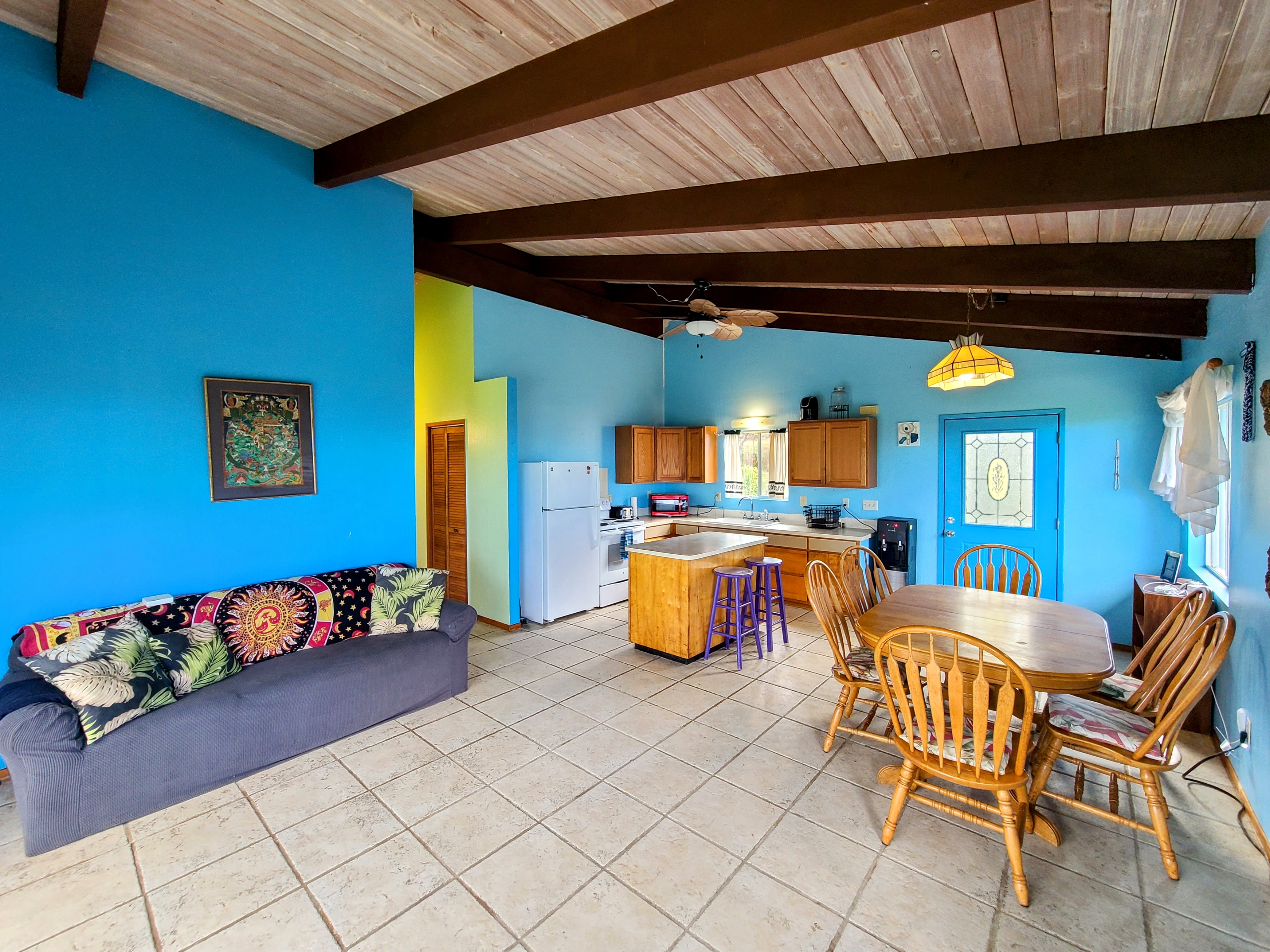 a dining room with furniture and a kitchen view