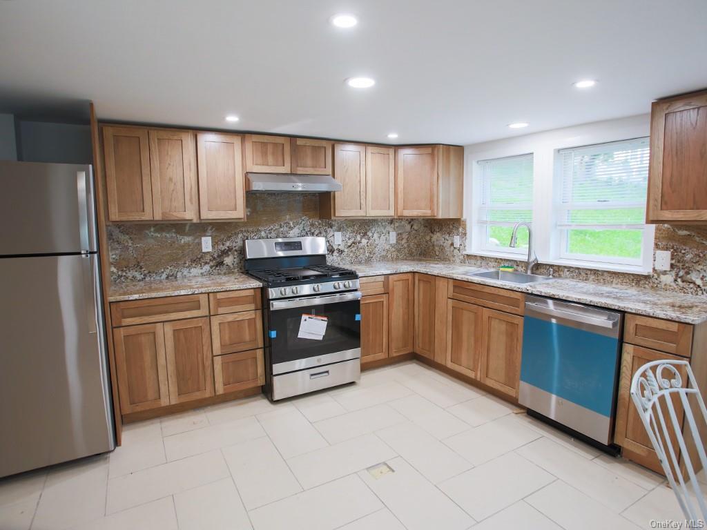 a kitchen with a sink stove and refrigerator