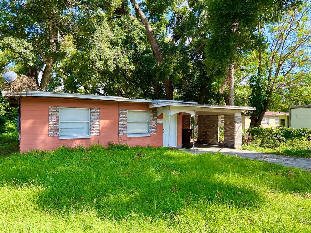 a front view of house with yard and trees