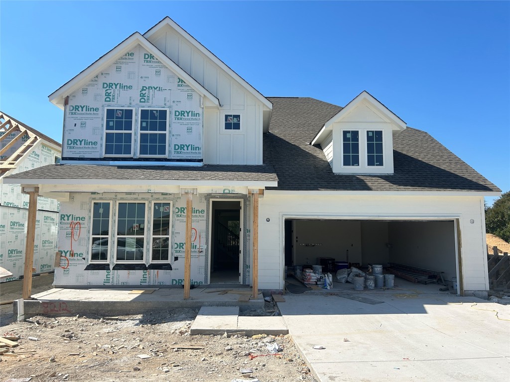 a view of a house with large windows and a yard