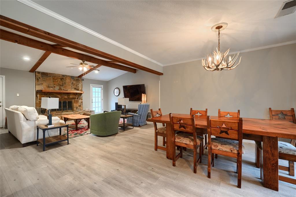 a living room with furniture a dining table and a chandelier