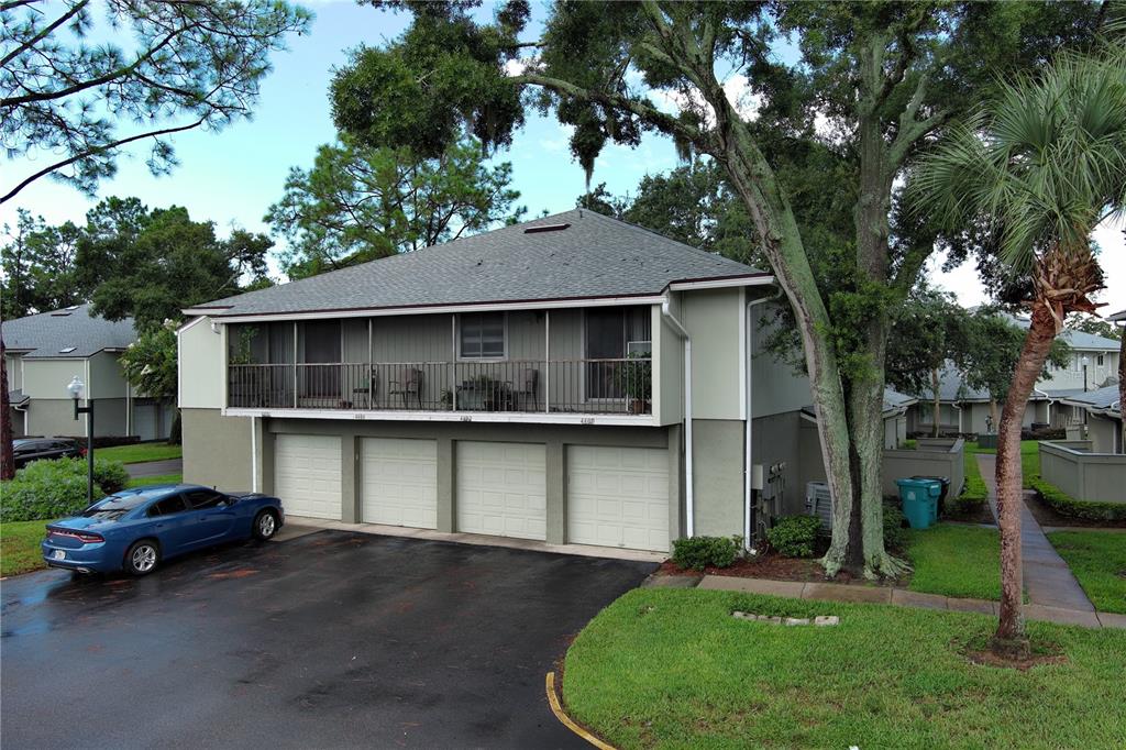 a view of a house with a garden and parking