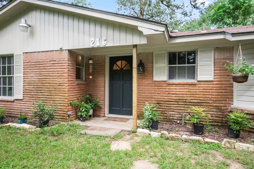 a front view of a house with plants