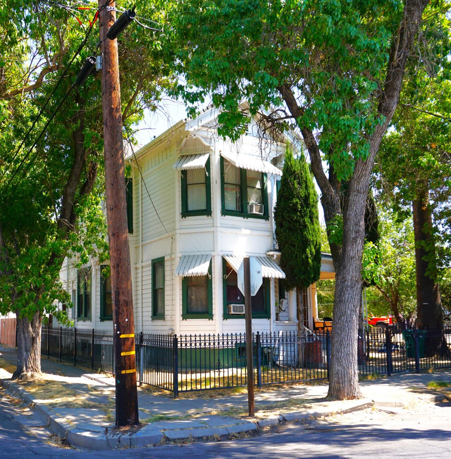 a front view of a house with a tree