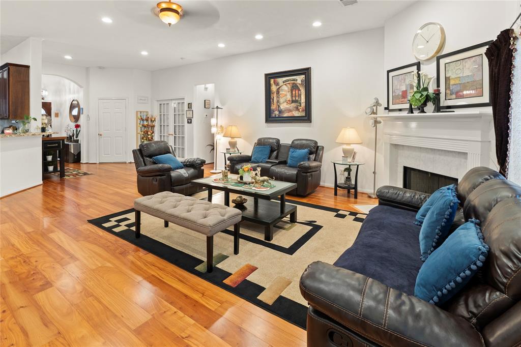 Bright & inviting family living room with a cozy gas fireplace and stylish wood flooring.