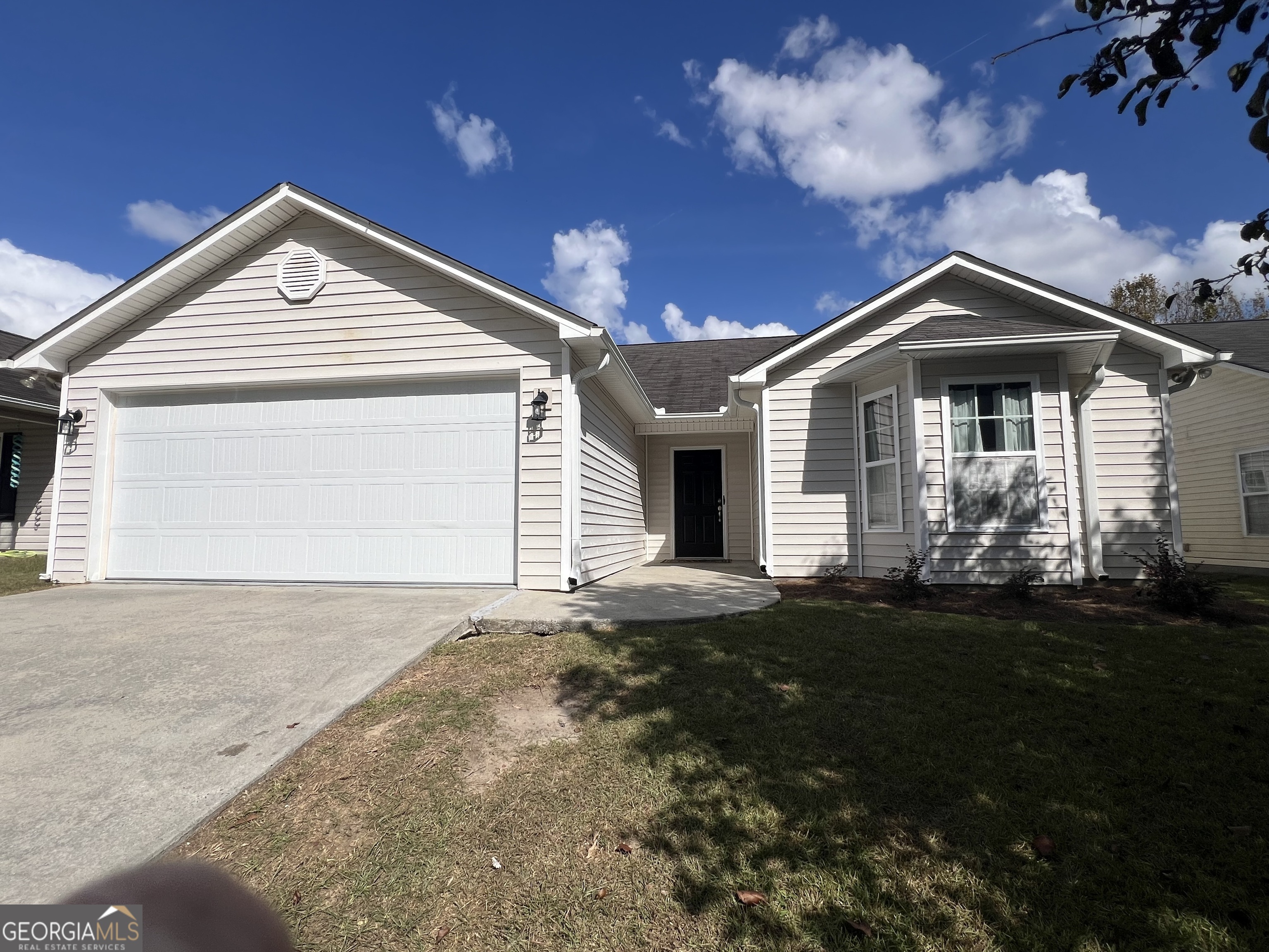 a front view of a house with a yard and garage