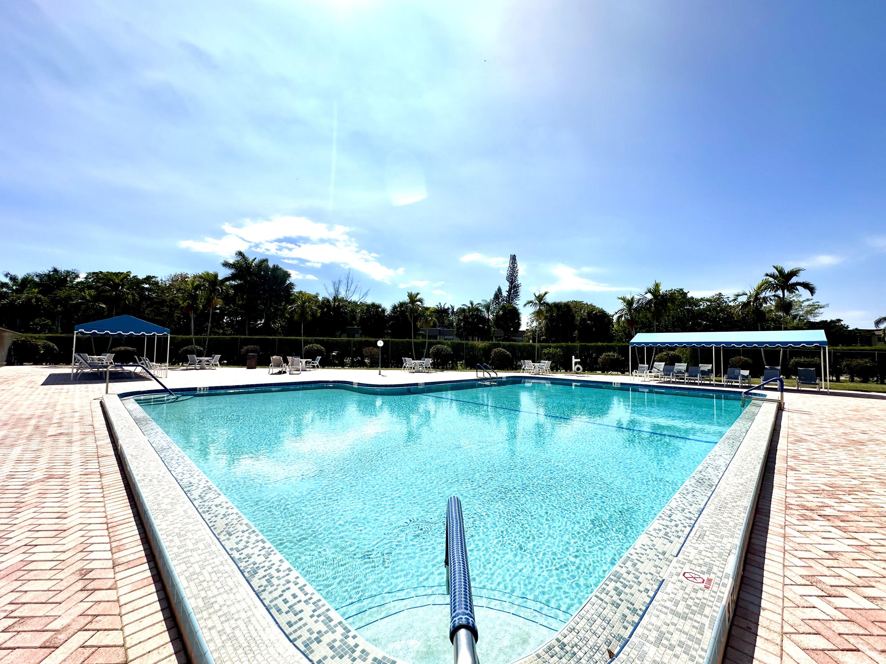 a view of a swimming pool with an outdoor seating