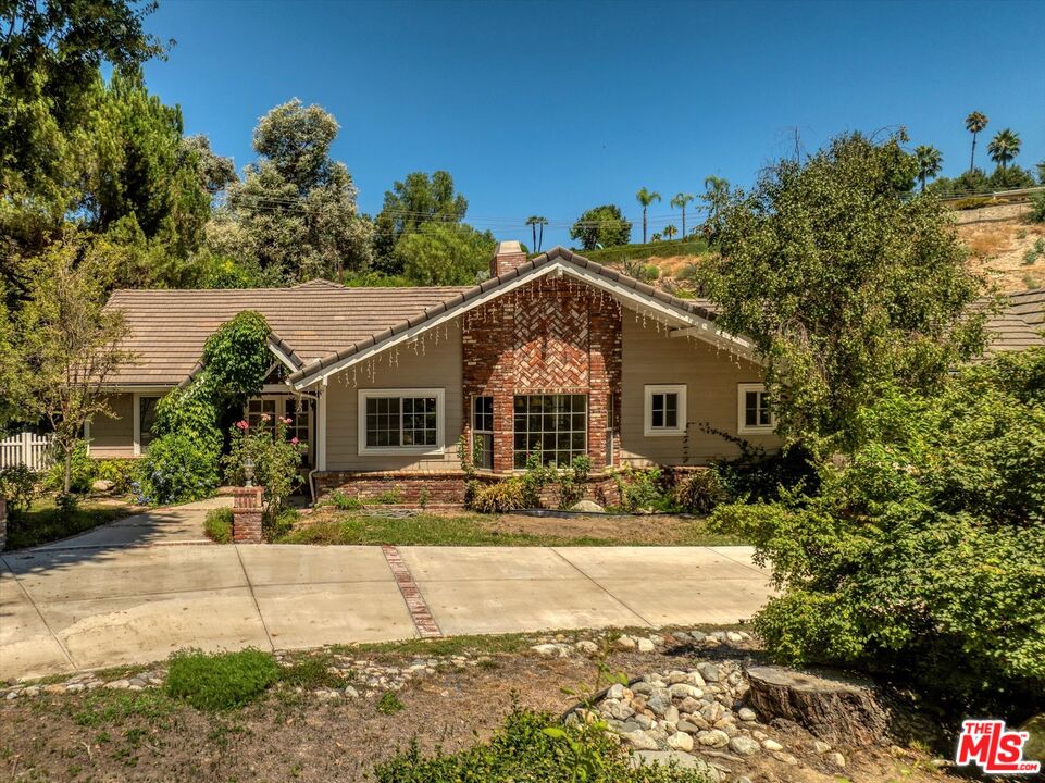 a view of house with outdoor space and sitting area