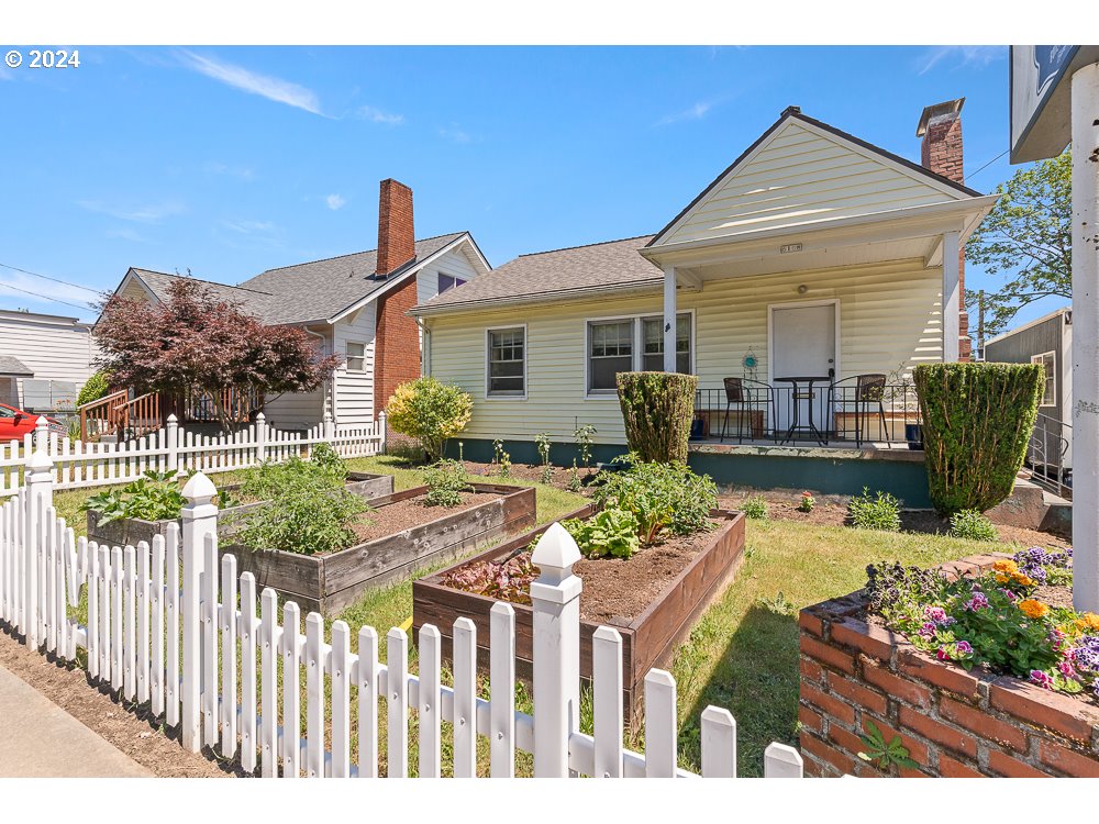 a front view of house with wooden fence