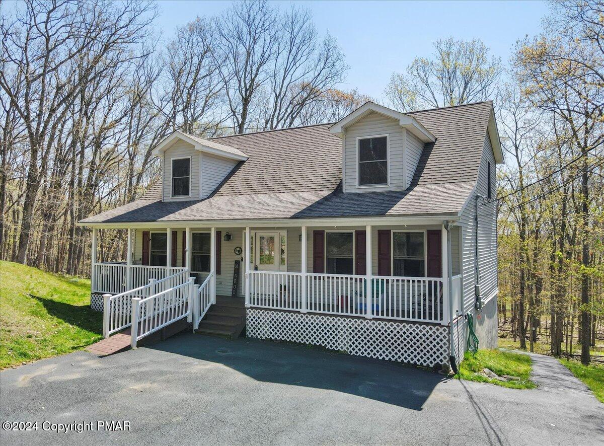 a view of a house with a yard and wooden fence